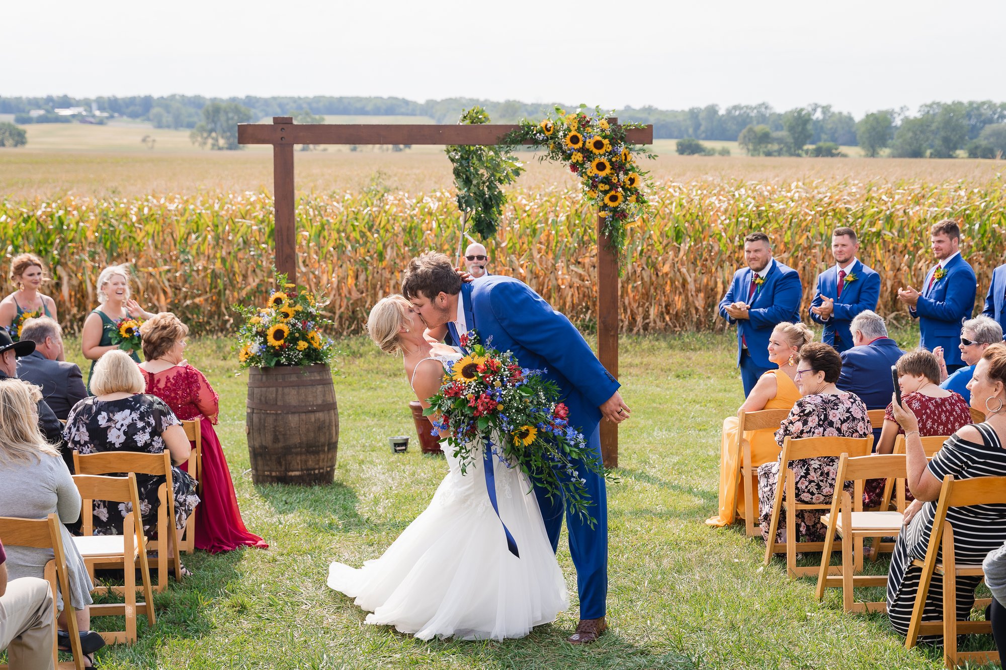 A ceremony arch dressed with sunflowers.
