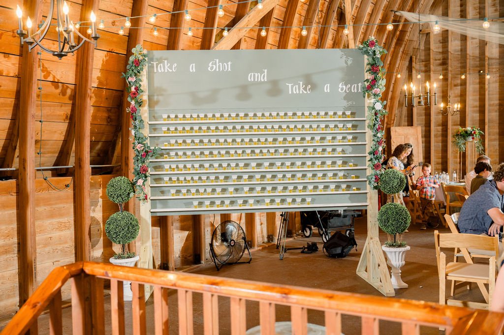 A hand-lettered seating sign inside the barn.