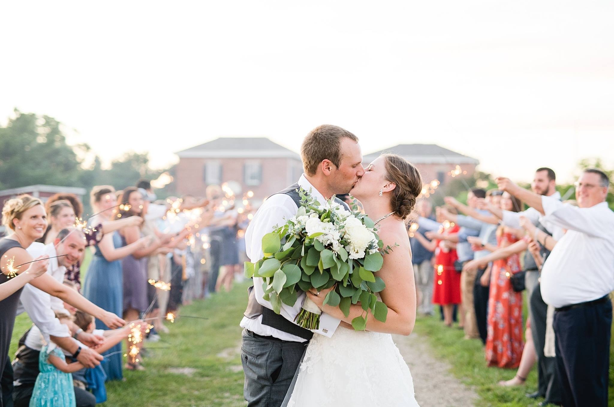 Guests lining both sides of the path for the couple's send-off.