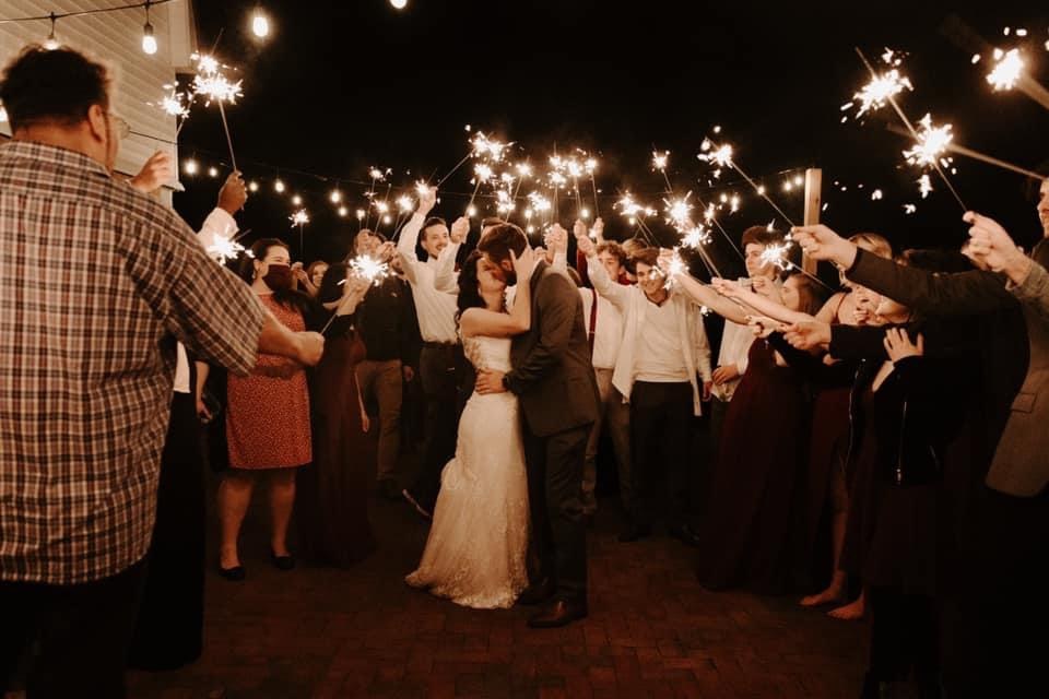Wedding guests form a sparkler line around the newlyweds at the end of the night.